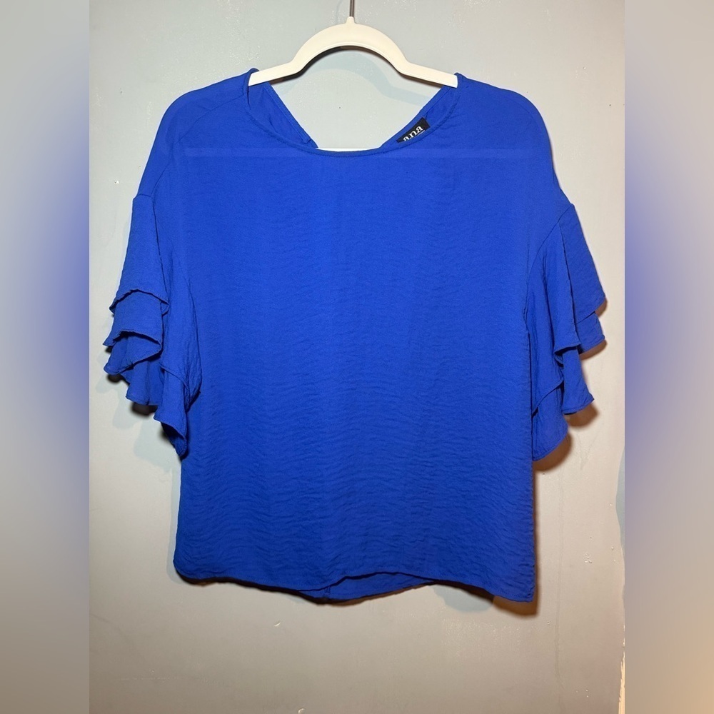 The a.n.a Blue Ruffled Short Sleeve Blouse ties in the back for added detail.